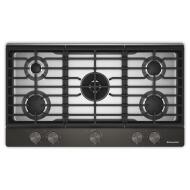 Top view of a black 36-inch gas cooktop featuring five burners, an integrated wok grate, and premium weighted knobs, part of Cooktops and Gas Cooktops collections for home improvement.