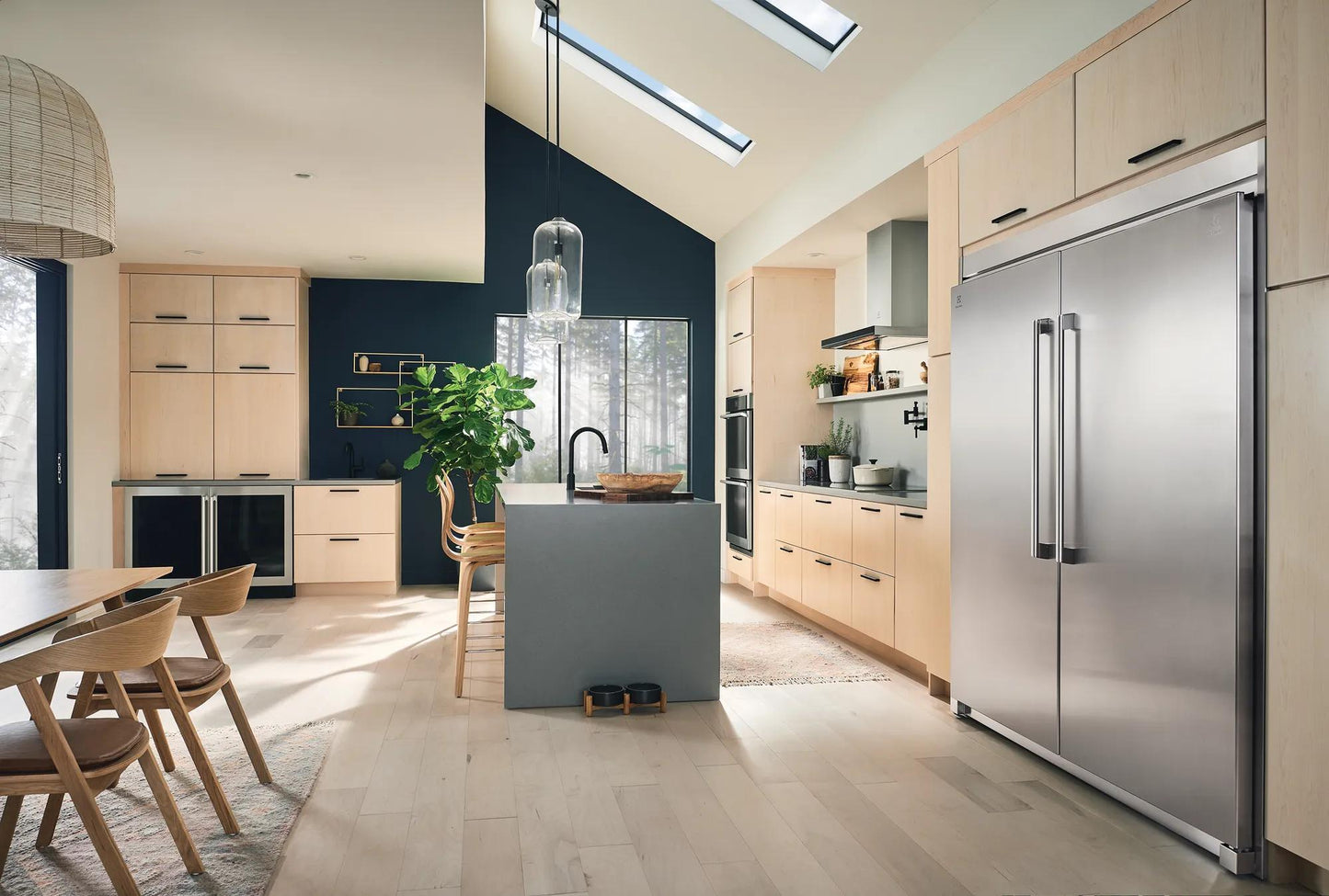 Spacious modern kitchen with light wood cabinets, large stainless steel freezer, and natural light in Appliances and Kitchen collections