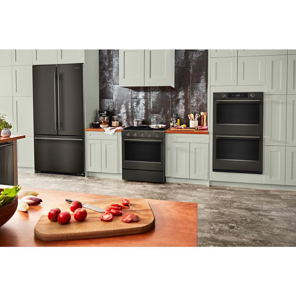 Modern kitchen setup with black ore refrigerator, stove, and 30-inch smart double wall oven in built-in cabinetry