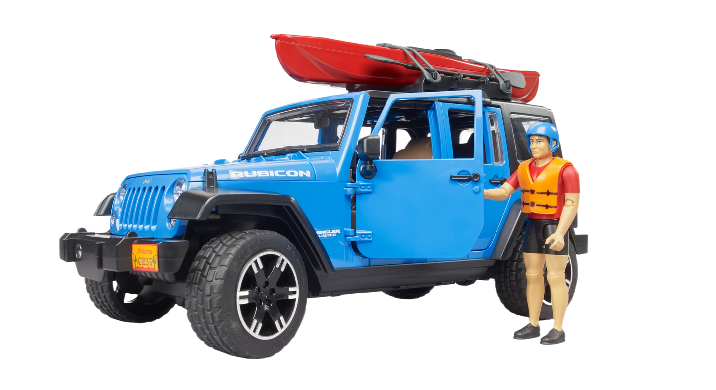 Blue Bruder Jeep Rubicon with red kayak on roof and action figure wearing life jacket standing beside vehicle
