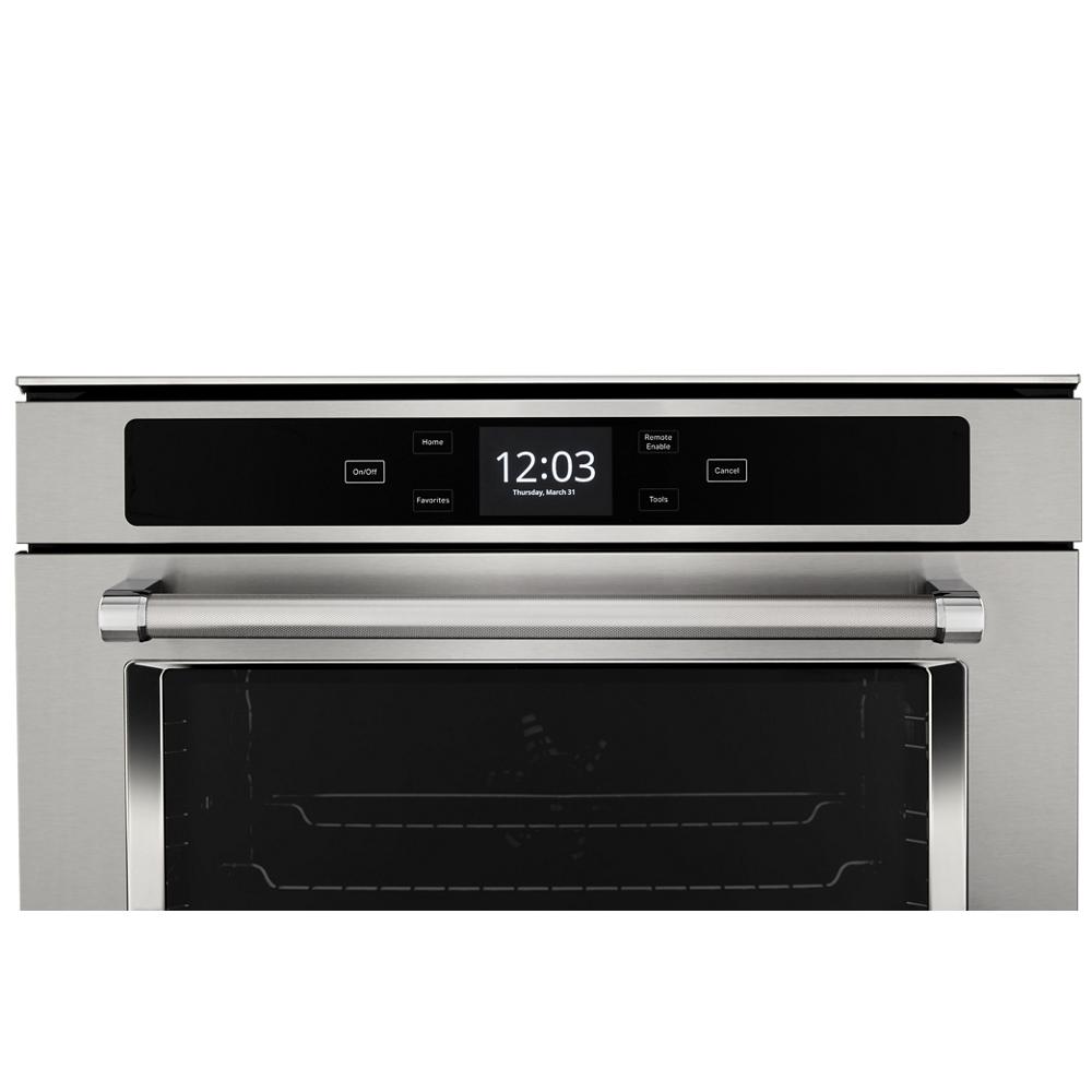 Stainless steel smart wall oven control panel with digital clock and touch buttons in KitchenAid Appliances collections