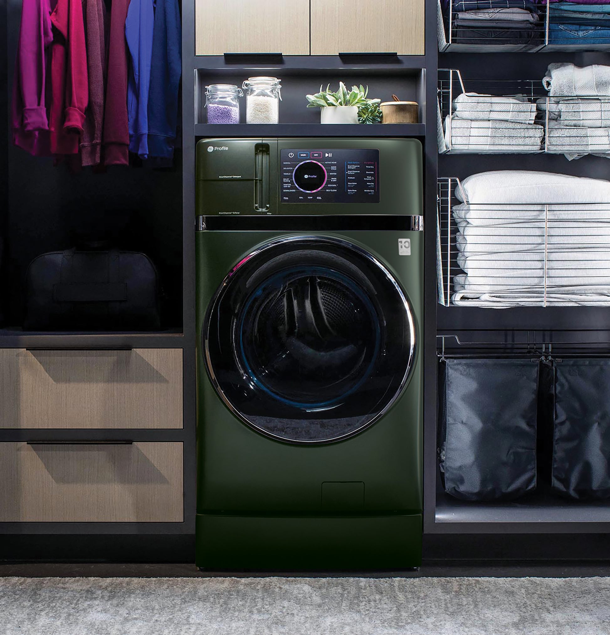 Dark green front load washer/dryer combo with digital display, integrated in sleek modern appliance laundry center setting.