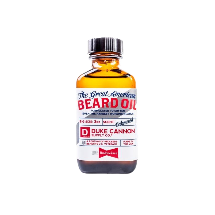 Amber glass bottle of beard oil with white label featuring red and blue text and black screw cap for grooming use