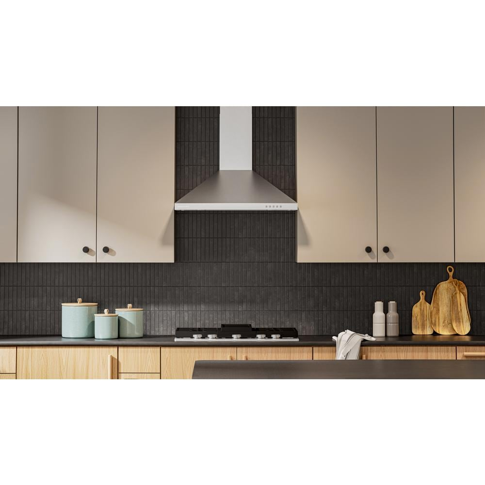 Stainless steel wall-mount canopy hood with 3-speed control over modern stovetop and dark tile backsplash