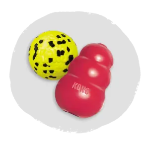 Red rubber chew toy with a textured surface paired with a yellow ball covered in black irregular spots, shown on a light gray background.