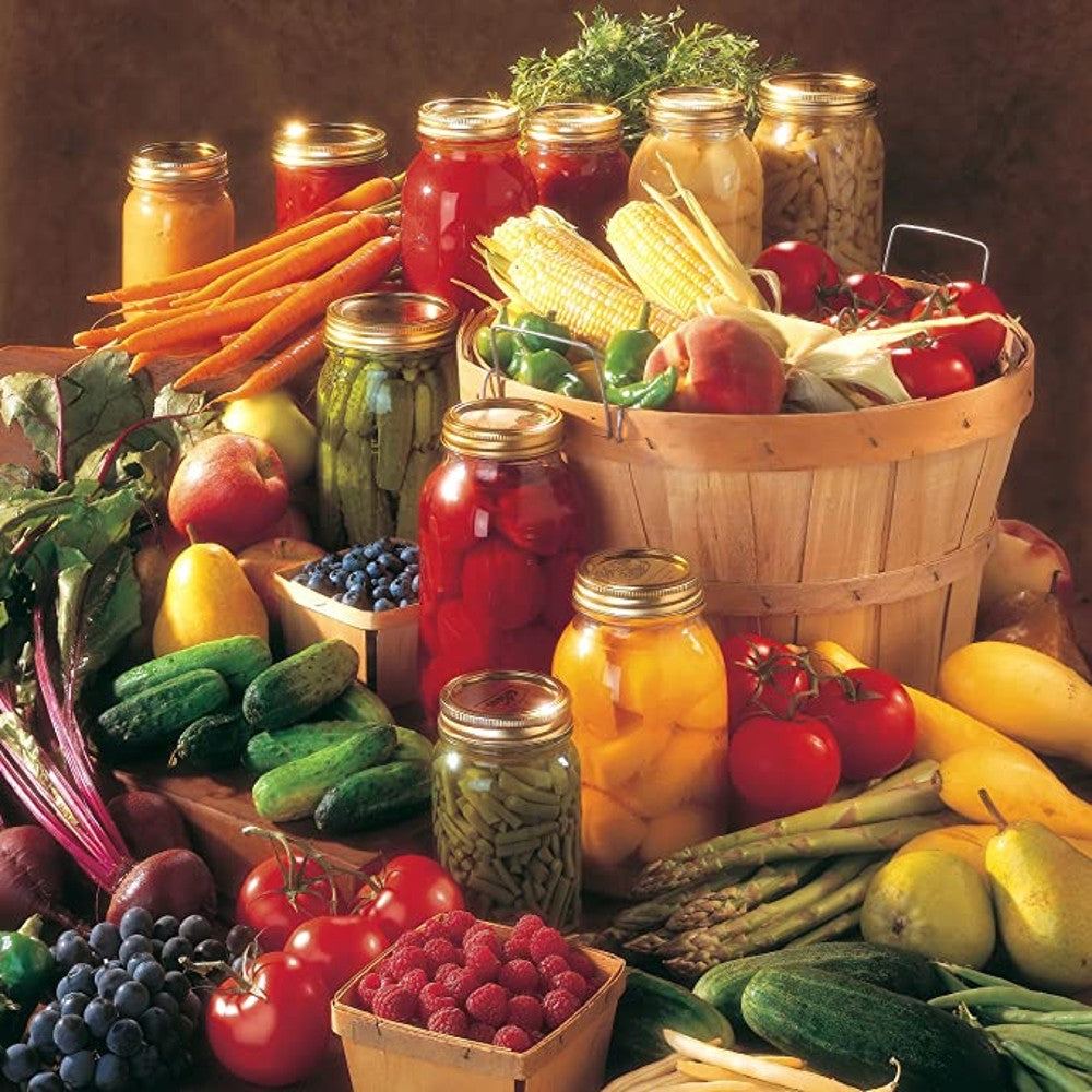Assortment of fresh vegetables and jars of preserved fruits and pickles arranged on a wooden surface