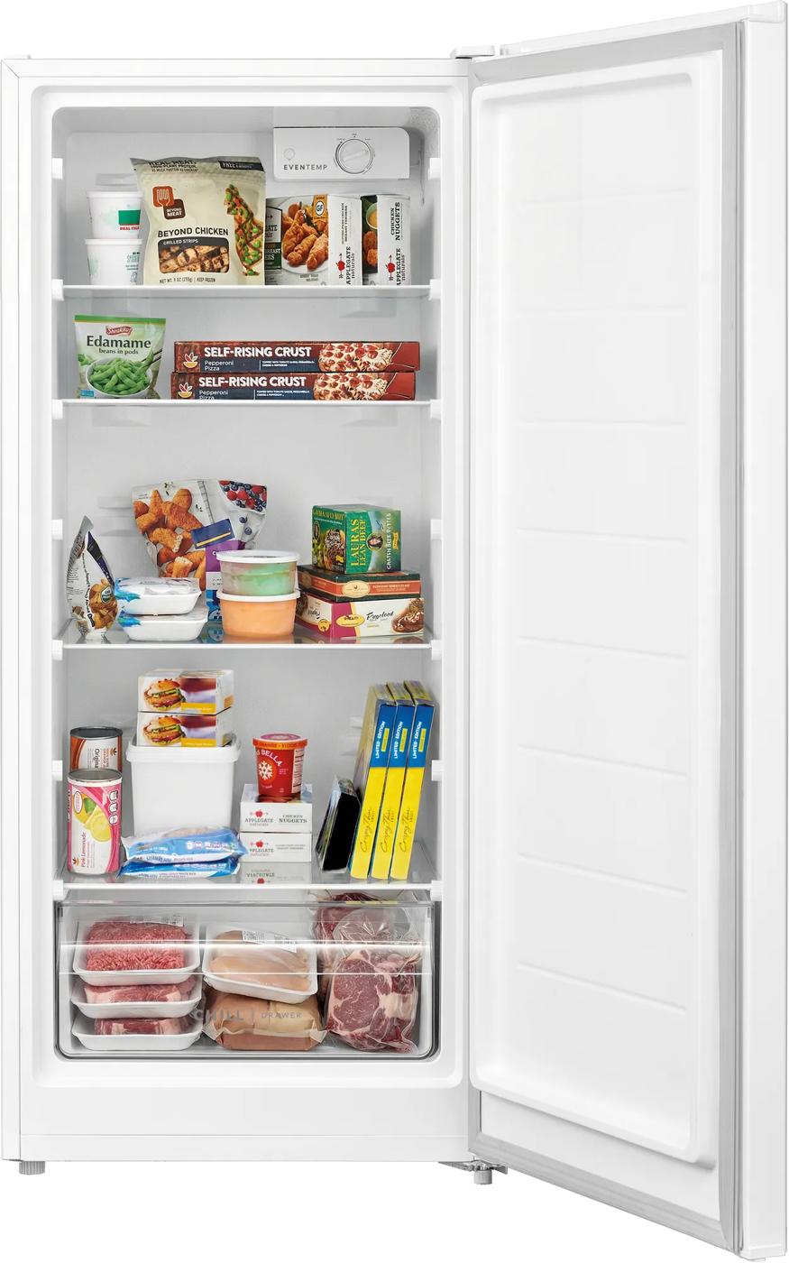 Open white upright freezer showing organized frozen groceries on adjustable shelves and clear storage drawers, suitable for Freezers & Ice Makers and Kitchen & Kitchenware collections.