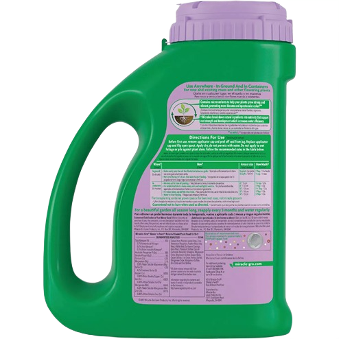 Green plant food container with purple lid showing usage instructions for lawn and garden plant care collections