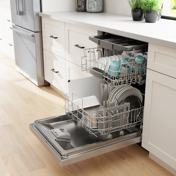 Open stainless steel dishwasher with upper and lower racks loaded with dishes in modern kitchen setting