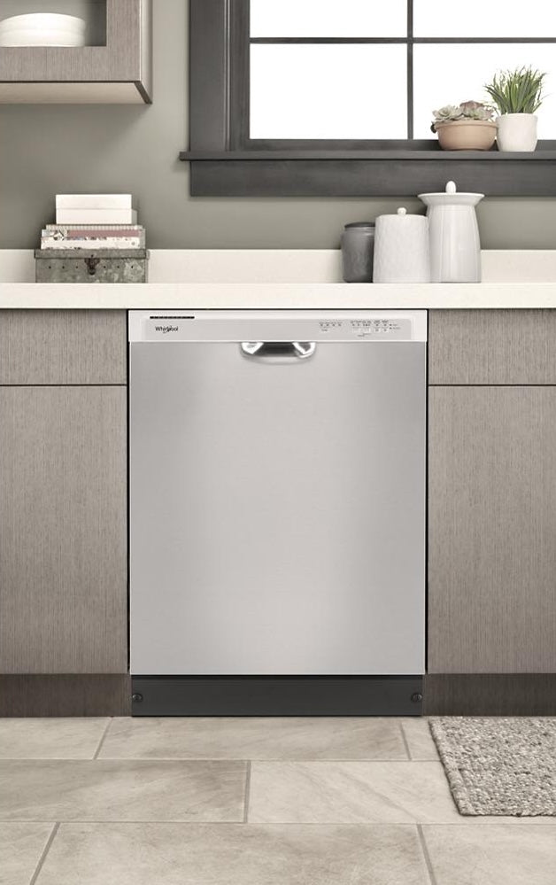 Built-in stainless steel quiet dishwasher with top control panel set in modern kitchen cabinetry and tile flooring