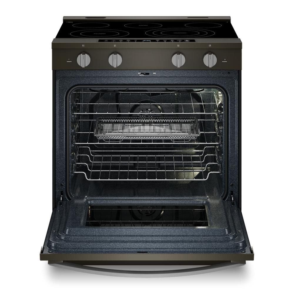 Open 30-inch smart electric range showing interior racks and Air Cooking Technology basket from kitchen appliances collection