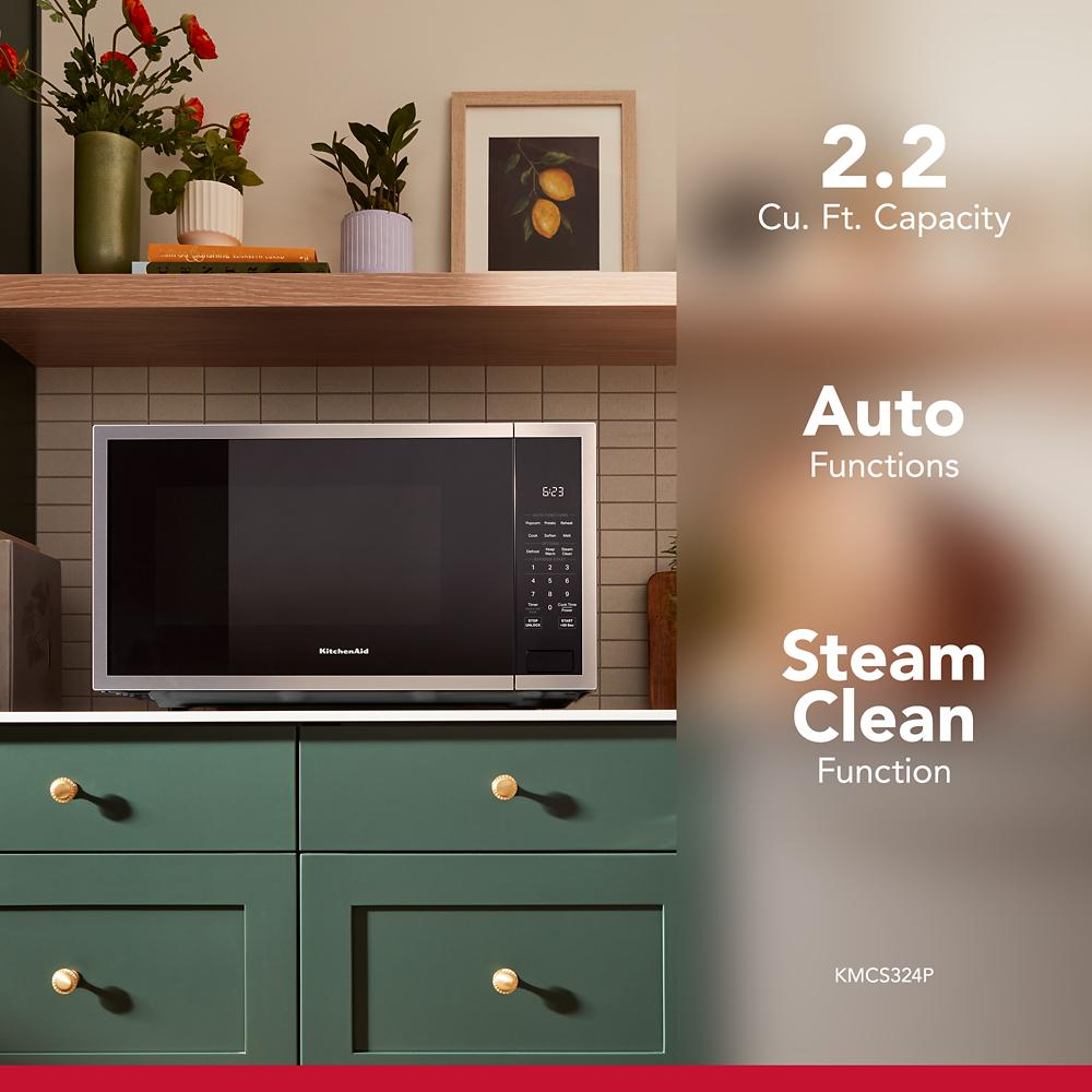 KitchenAid 2.2 Cu. Ft. countertop microwave with digital control panel on green cabinetry in kitchenware collection