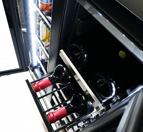 Dual zone beverage center drawer with red wine bottles stored horizontally on wooden racks in kitchen appliances collection
