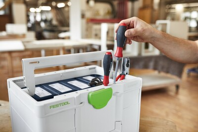 White and green modular Festool toolbox with screwdrivers arranged on top for workshop tool storage and organization