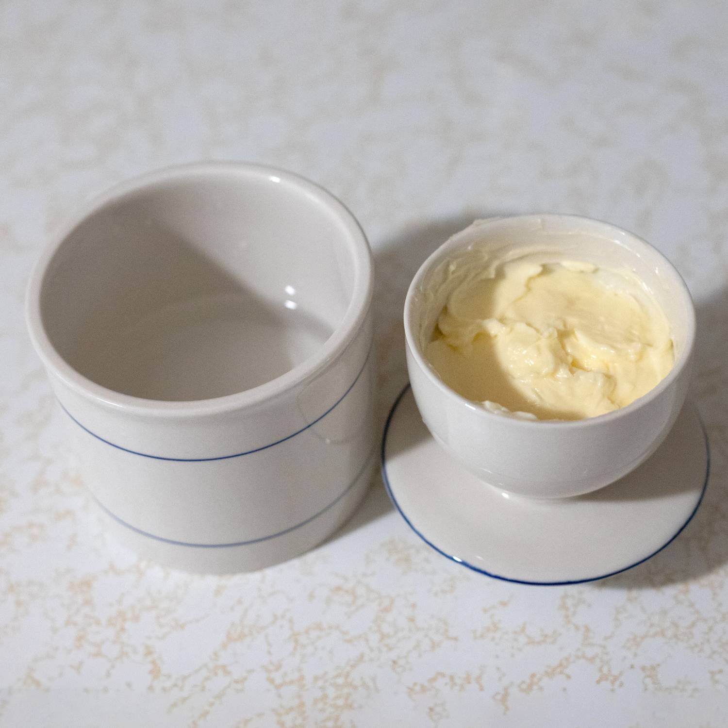 Cream stoneware butter keeper with thin blue stripes, suitable for kitchenware and under $50 collections
