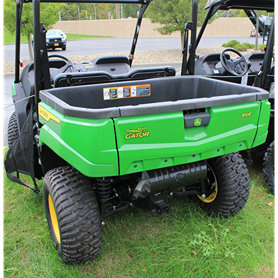Rear cargo bed and rugged tires on green John Deere utility vehicle ready for outdoor and home improvement tasks