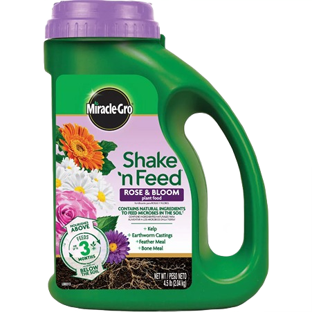 Green container of plant food with purple cap and floral label for lawn and garden plant care collections