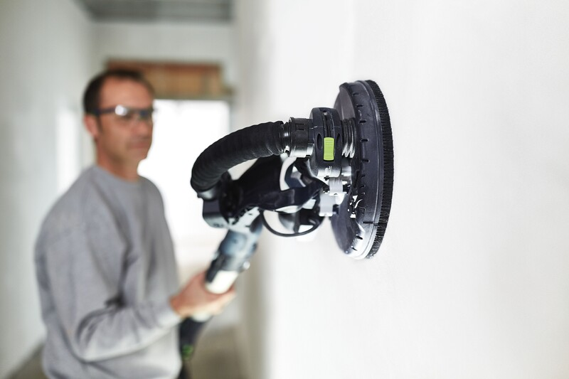 Person using a Festool Planex sanding tool with brush segment for smooth wall finishes in home improvement tasks