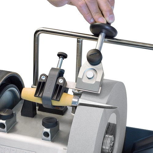 Metal and plastic small knife holder jig with wooden handle clamped on a sharpening stone for home improvement tools