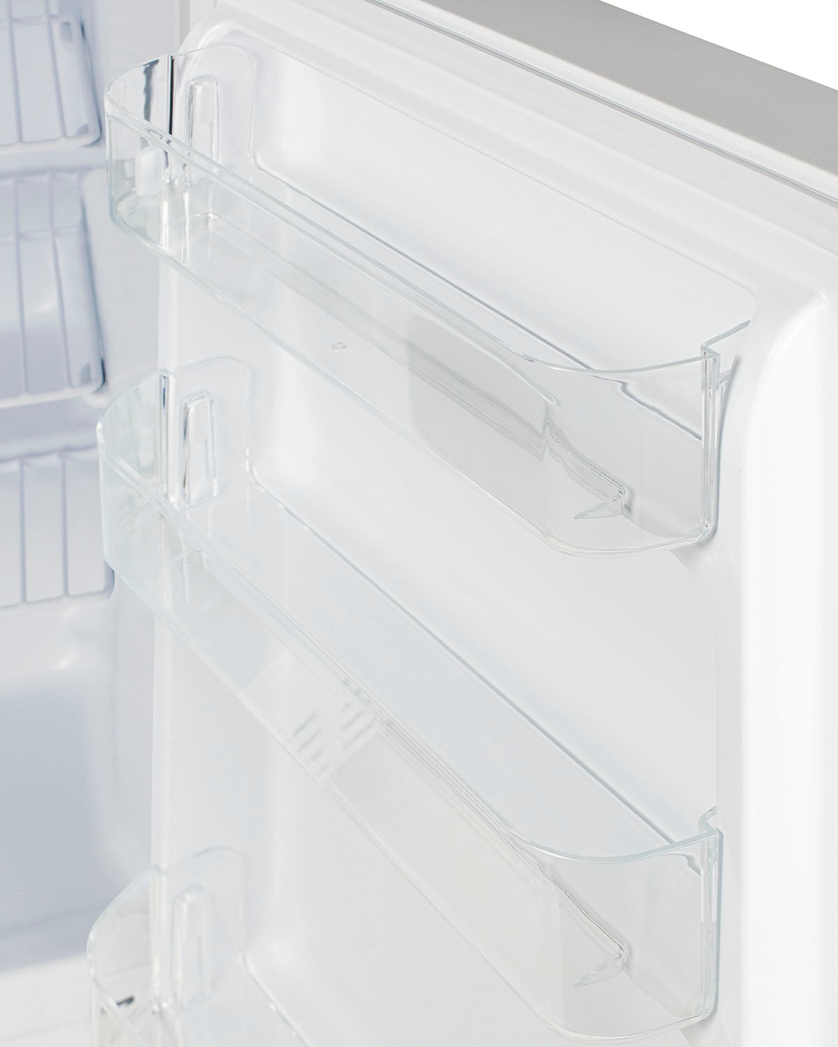 Close-up of clear door bins inside a white built-in freezer for home kitchen appliances and storage organization