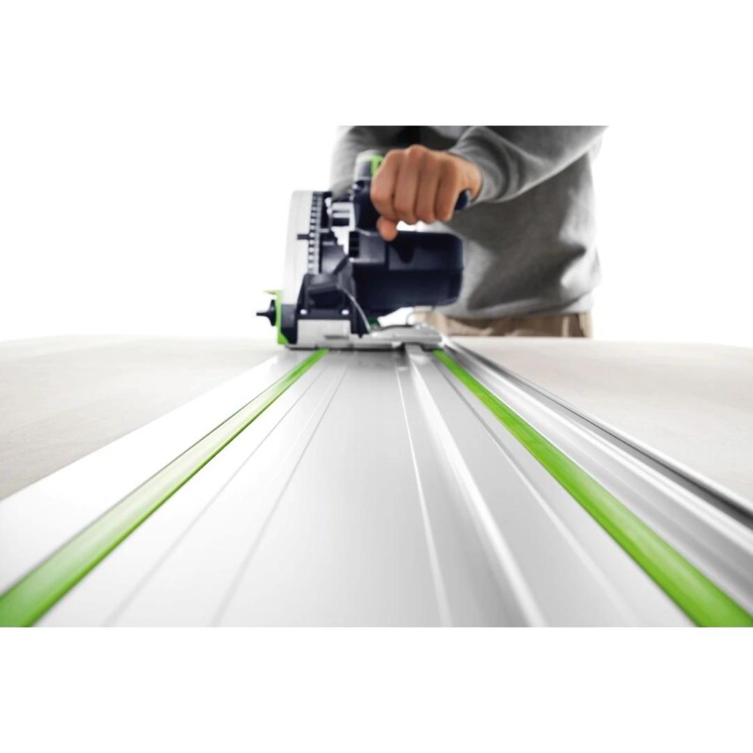 Person guiding a power saw along a Festool aluminum guide rail for accurate woodworking straight cuts
