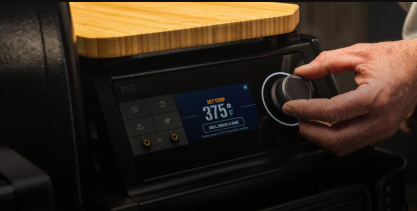 Close-up of digital control panel with temperature dial set to 375°F on a wood pellet grill in outdoor living collection