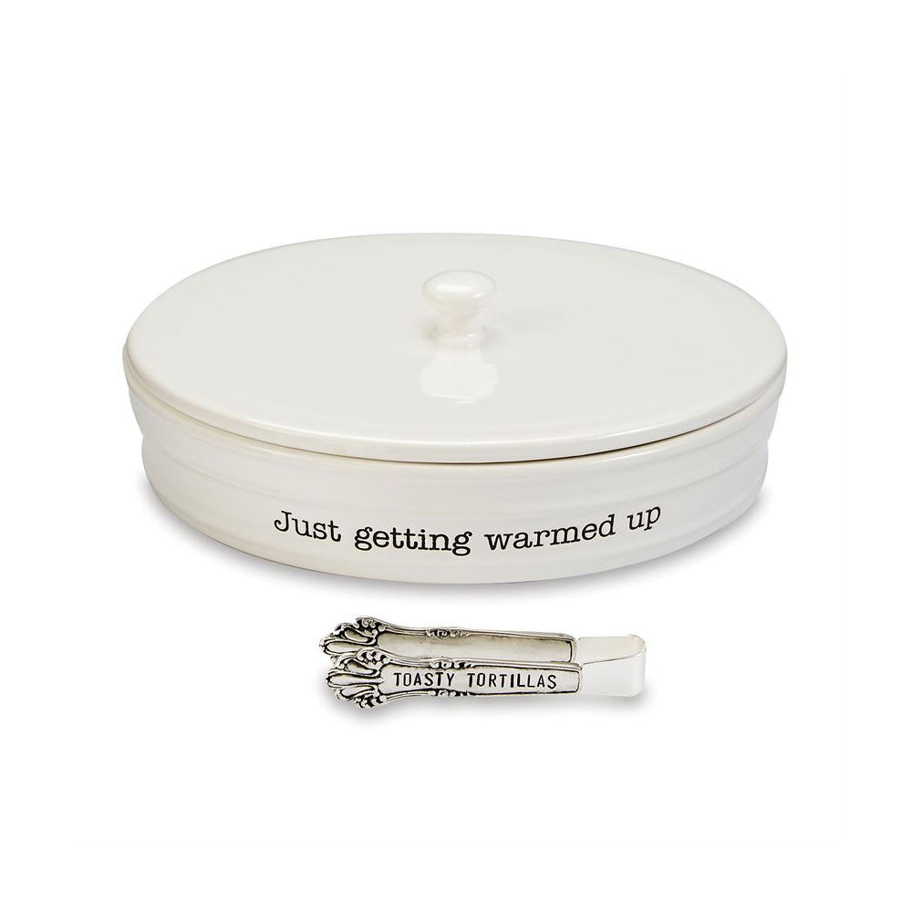 White ceramic tortilla warmer with matching lid and decorative tongs featuring playful text accents