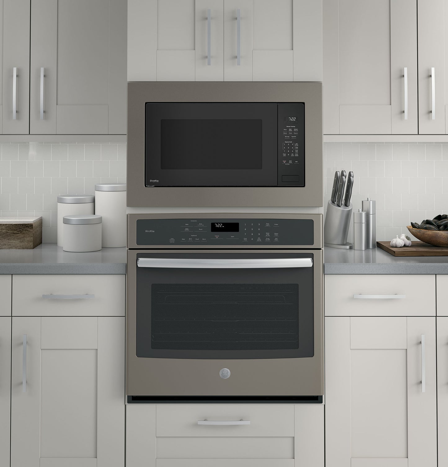 Built-in stainless steel microwave with digital control panel above matching built-in oven in modern kitchen setting