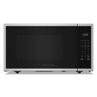 Stainless steel countertop microwave with digital display and preset cooking buttons in kitchen appliance collection