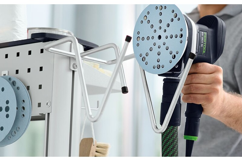 Two-pronged metal hook with rubber tips holding a power sander on a workshop organization board