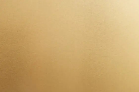 Close-up view of a smooth, matte gold surface with a soft, even texture suitable for home improvement and decorative finishes.