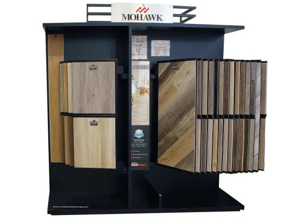Freestanding display rack featuring a variety of wood-look flooring samples in natural and warm tones for home improvement projects.