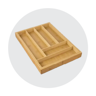 Light wood drawer organizer with multiple compartments of varying sizes arranged to separate small household items, shown on a soft gray circular background.