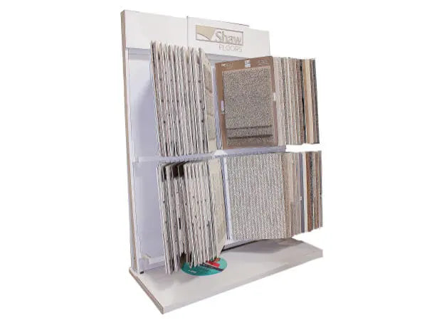 Freestanding floor sample display featuring various carpet swatches in neutral tones organized on white panels for home improvement.